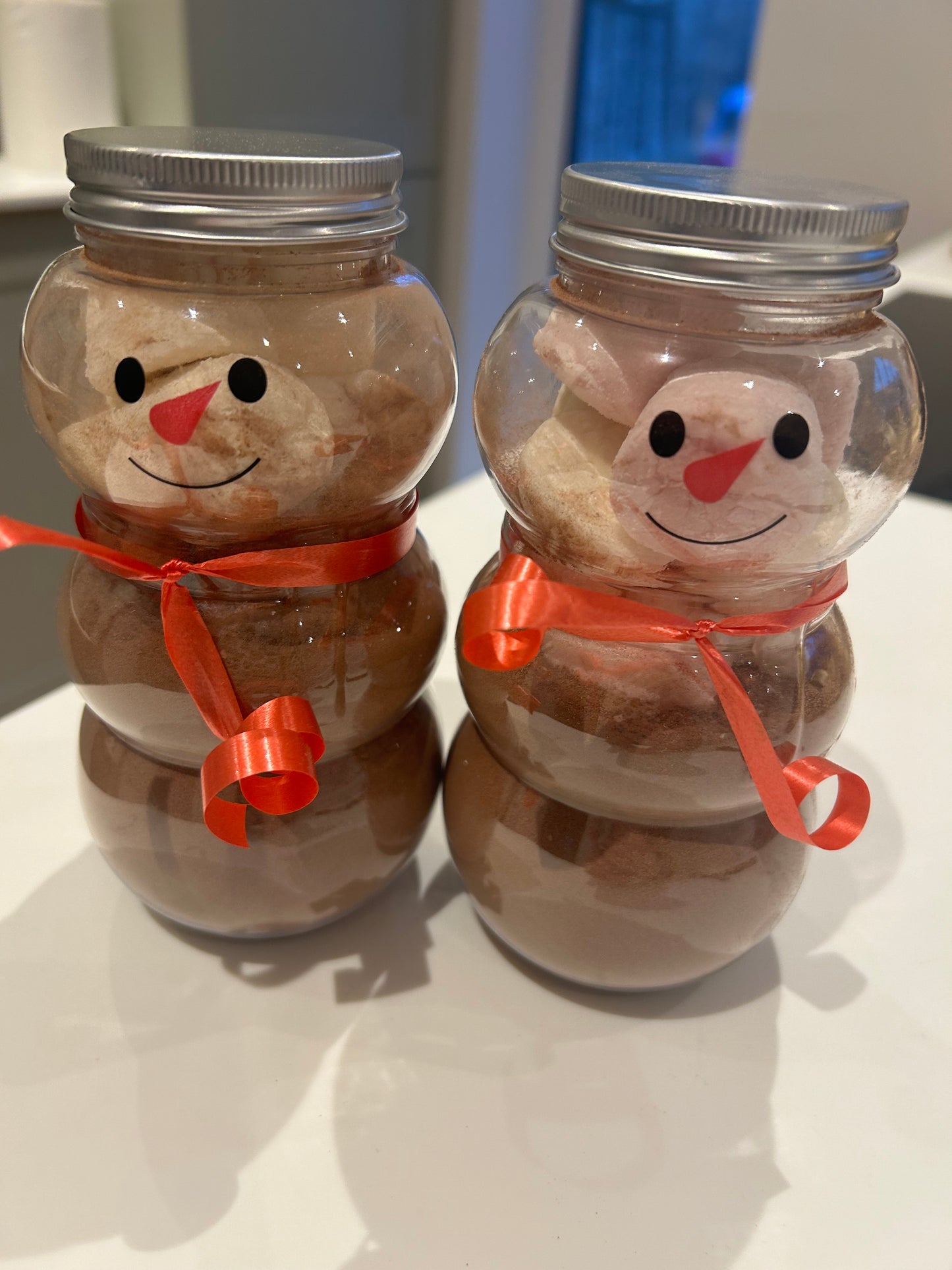 Snowman drinking jar filled with hot chocolate and marshmallows